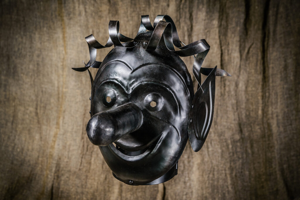 a medieval punishment mask, also known as a "shame mask." It was used to publicly humiliate and punish individuals by forcing them to wear the mask, which often had exaggerated features to mock specific behaviors or offenses.