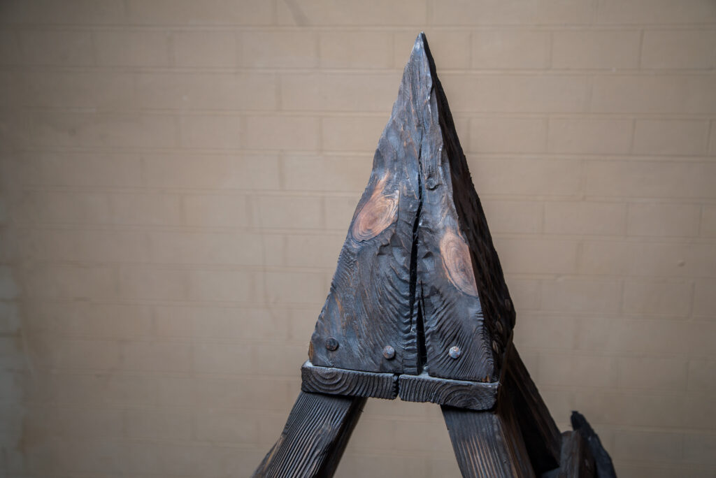 a close-up of a wooden torture device known as the Judas Cradle